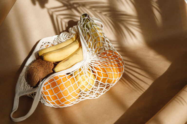 Creative summer food still life with bananas, coconut, oranges and lemons.